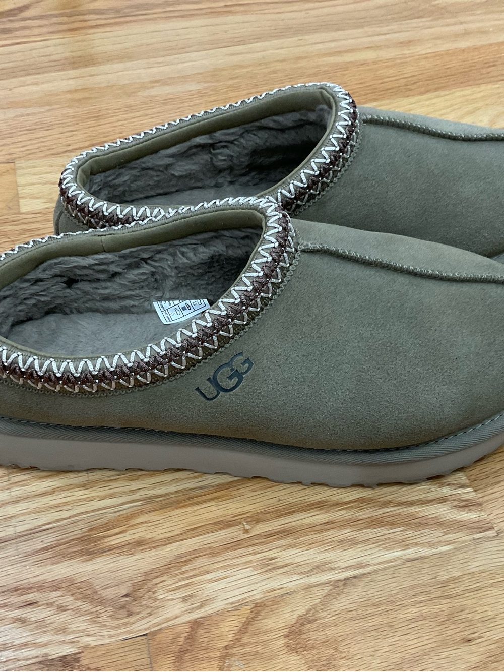 UGG Women’s Olive Green Suede Shearling-Lined Tasman slippers.